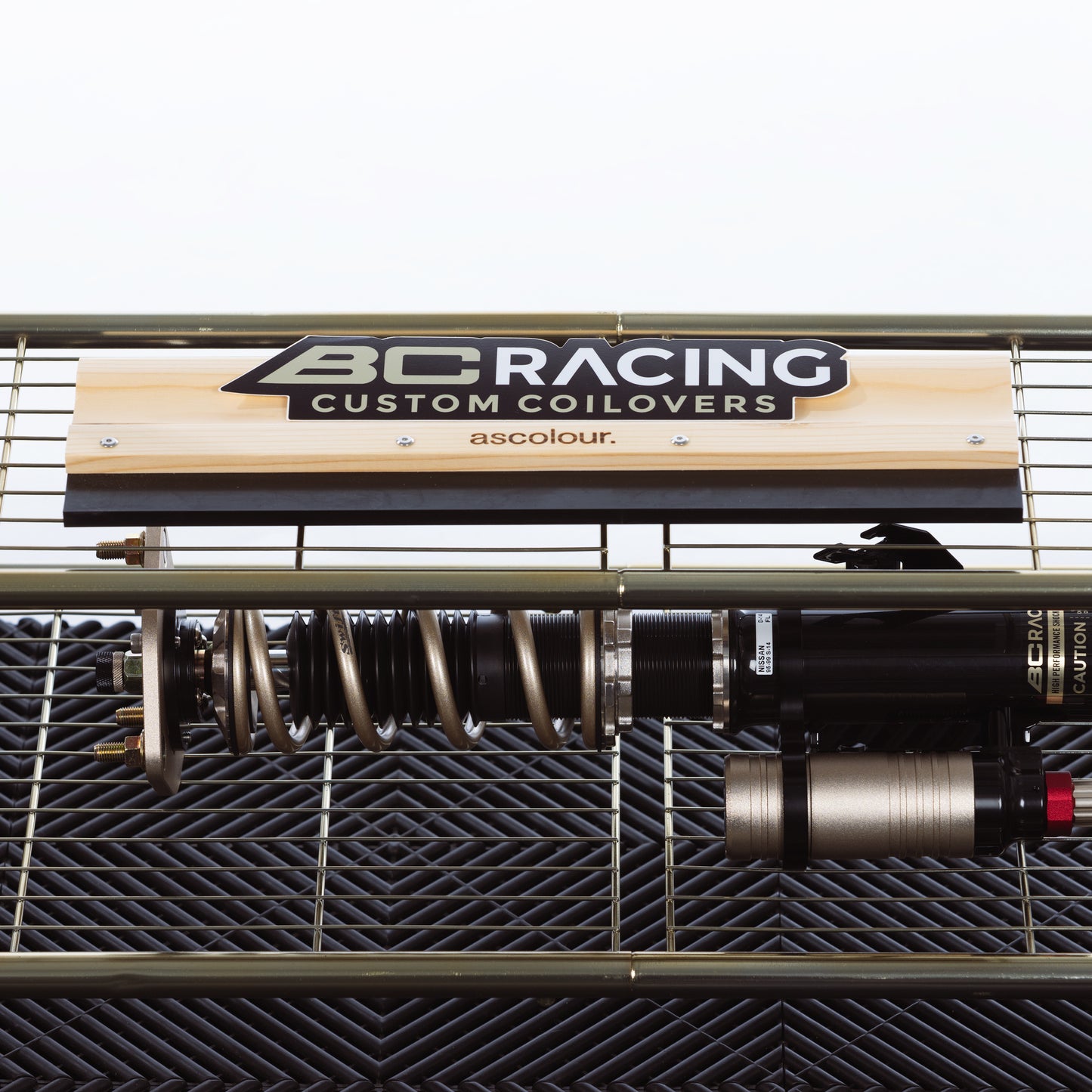 BC Racing custom coilovers sticker on a shelf with a coilover on the bottom