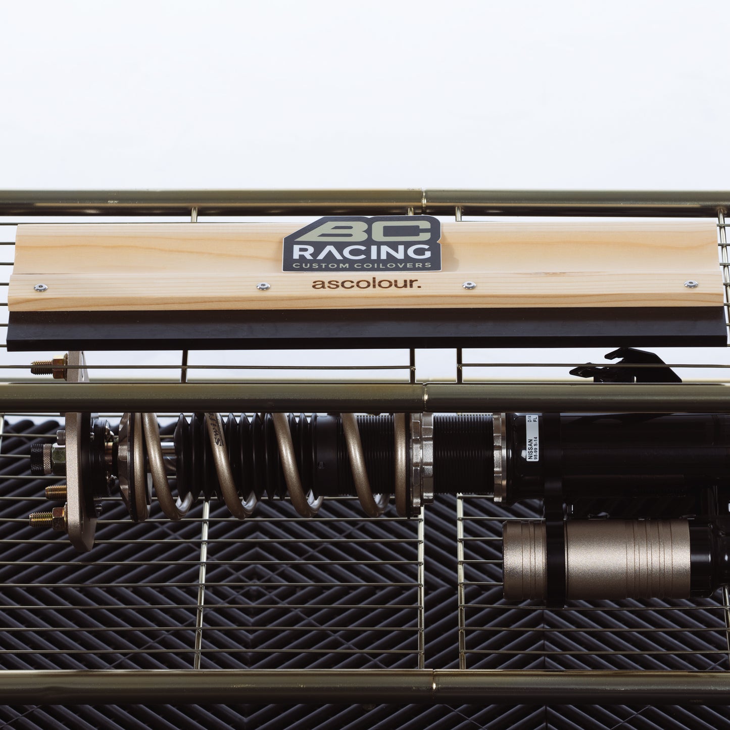 BC Racing stacked logo sticker on shelf with coilover on the bottom