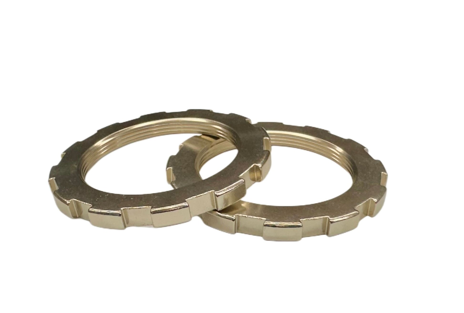 Gold BC Racing rear height adjuster lock rings on a white background