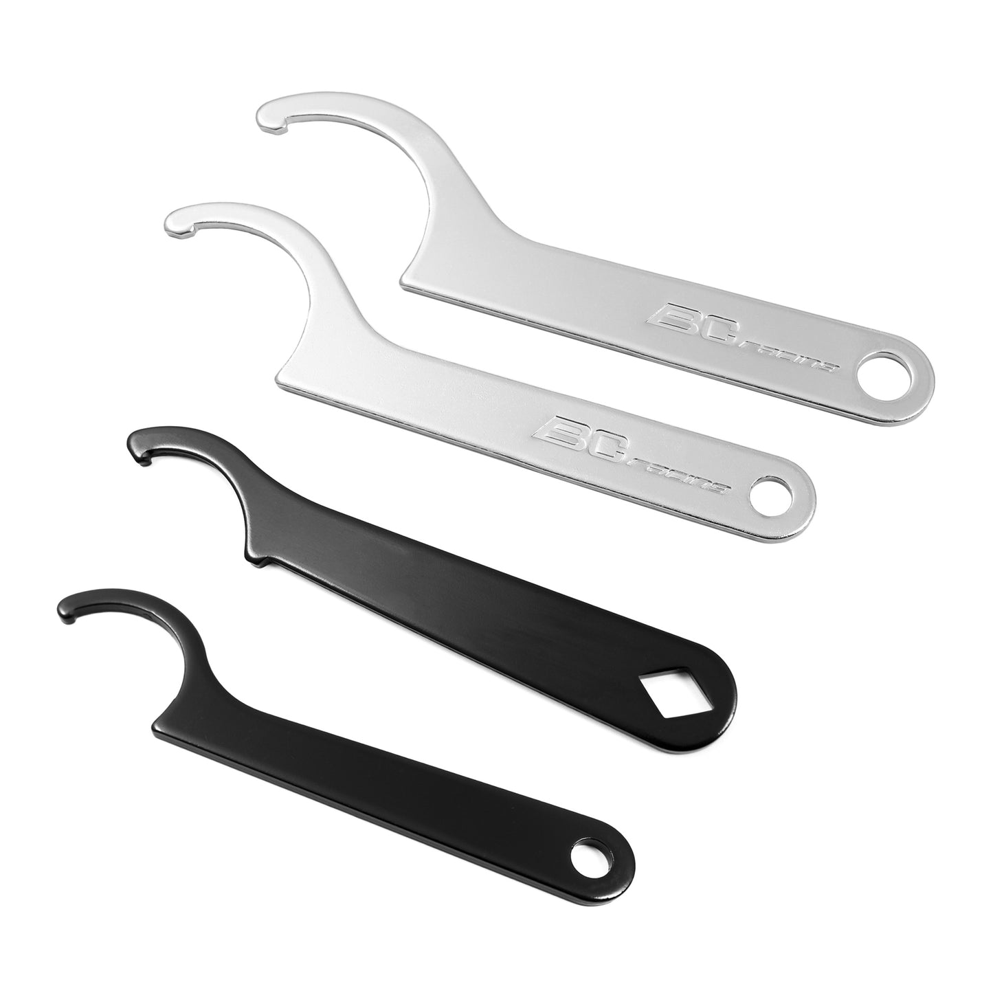 A set of black and silver metal spanner wrenches on white background